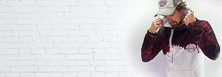 man wearing an embroidered bordeaux hat and sublimated hoodie