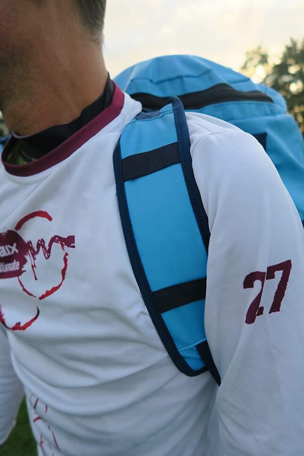 strap of light blue waterproof bag on man's shoulder