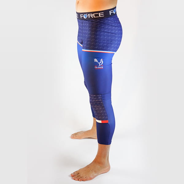 vue du côté gauche des jambes de l'homme portant de longs collants bleus avec ceinture Force